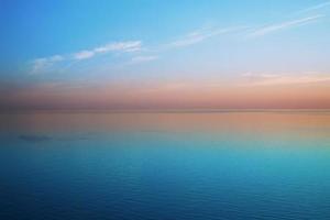 Delicious delicate sunset over a calm sea photo