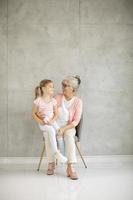 Grandmother holding granddaughter with copy space photo