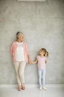 Grandmother holding granddaughter's hand with copy space photo