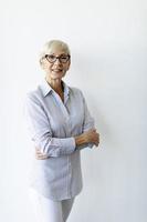 Vertical view of mature businesswoman with arms crossed photo