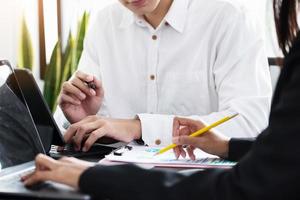 Two young business executives are discussing to change their business concept to increase profits and the strength of their busines photo