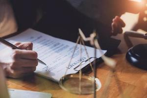 lawyer woman hoding pen with contract or agreement document to customer for signing in courtroom legal photo