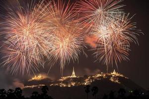 Annual festival of Khao Wang temple with colorful fireworks on hill at night photo