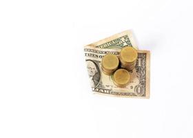 Close up of dollar banknote and money coins stack on white background photo