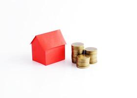 Red home paper and coins stack for loan money concept photo