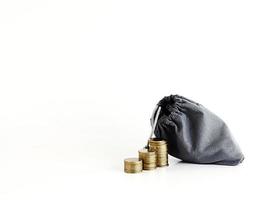 Coins stack and money bag isolated on white background photo