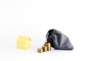 Coins stack and money bag with house paper for home loans concept photo