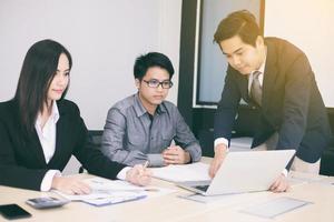 Three business people in a meeting photo