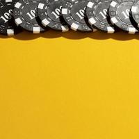 Yellow background with border of casino tokens photo