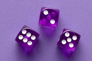 Purple dices on purple background photo