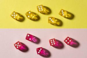 Yellow and pink dice on colorful background photo