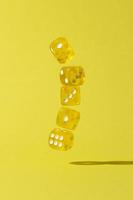 Falling yellow dice on yellow background