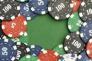 Casino tokens on green background with blank space photo
