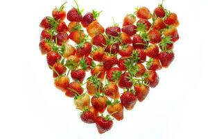Fresh strawberries in a heart shape isolated on white background photo