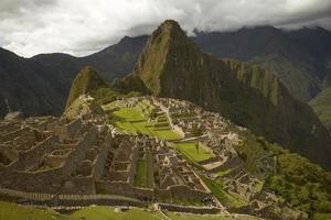 People Visiting Lost Incan City of Machu Picchu near Cusco in Peru photo
