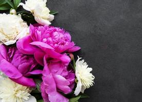 Peony flowers on a black concrete background photo