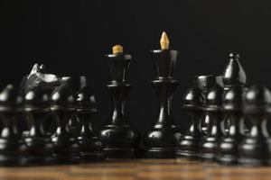 Black chess pieces on chess board photo