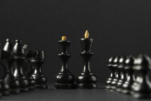 Black chess pieces on black background photo