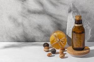 Minimal background of argan oil care composition photo