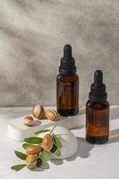 Minimal background of argan oil care composition photo