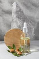 Minimal background of argan oil care composition photo