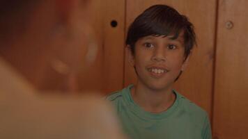 Boy talking with woman at table video