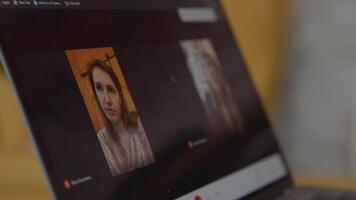 Two women on laptop screen during online meeting video