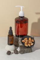 Minimal background of argan oil care composition photo