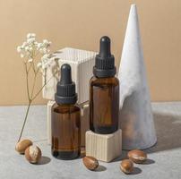 Minimal background of argan oil care composition photo