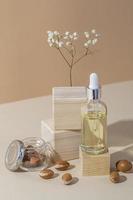 Minimal background of argan oil care composition photo