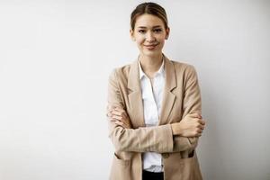 Businesswoman against white wall photo