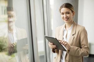 Woman holding tablet in modern office photo