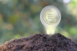 Bitcoin cryptocurrency coin on soil photo