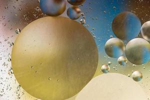 Colorful oil bubbles on water surface photo