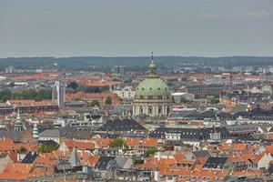 Skyline of scandinavian city of Copenhagen in Denmark during a cloudy day photo