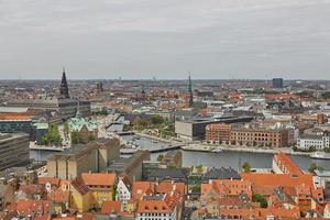 Skyline of scandinavian city of Copenhagen in Denmark during a cloudy day photo