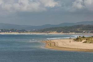 People enjoying a summer day on a beach in Santander Spain photo