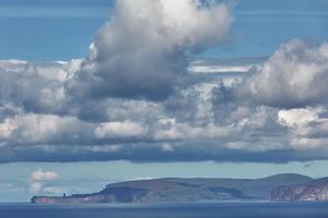 Orkney cliffs with dramatic sky seen from John oGroats over Atlantic ocean photo