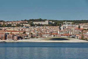 Cityline of Lisbon in Portugal over the Tagus river photo
