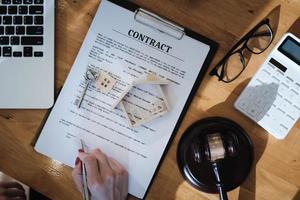 Lawyer checking agreement document before sending to client. photo