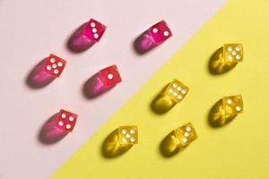 Yellow and pink dices on colorful background