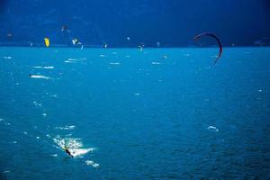 Kitesurfing in the early morning on Lake Garda at Limone sul Garda, Italy