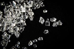 White sugar crystals on a black background photo