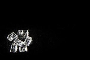 White sugar crystals on a black background photo