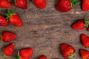 Tasty strawberries on a wooden table photo