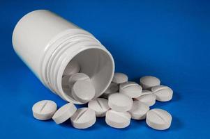 White medical pills and tablets with bottle photo