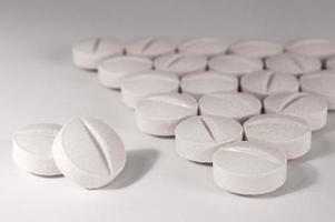 White medical pills and tablets with bottle photo