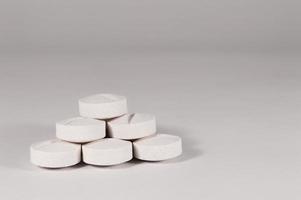 White medical pills and tablets with bottle photo