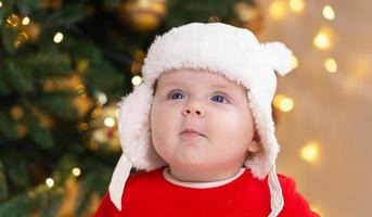 Christmas child is thoughtful dreamily surprised emotions photo