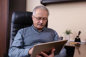 hombre mayor, lectura, noticias, en, tableta digital